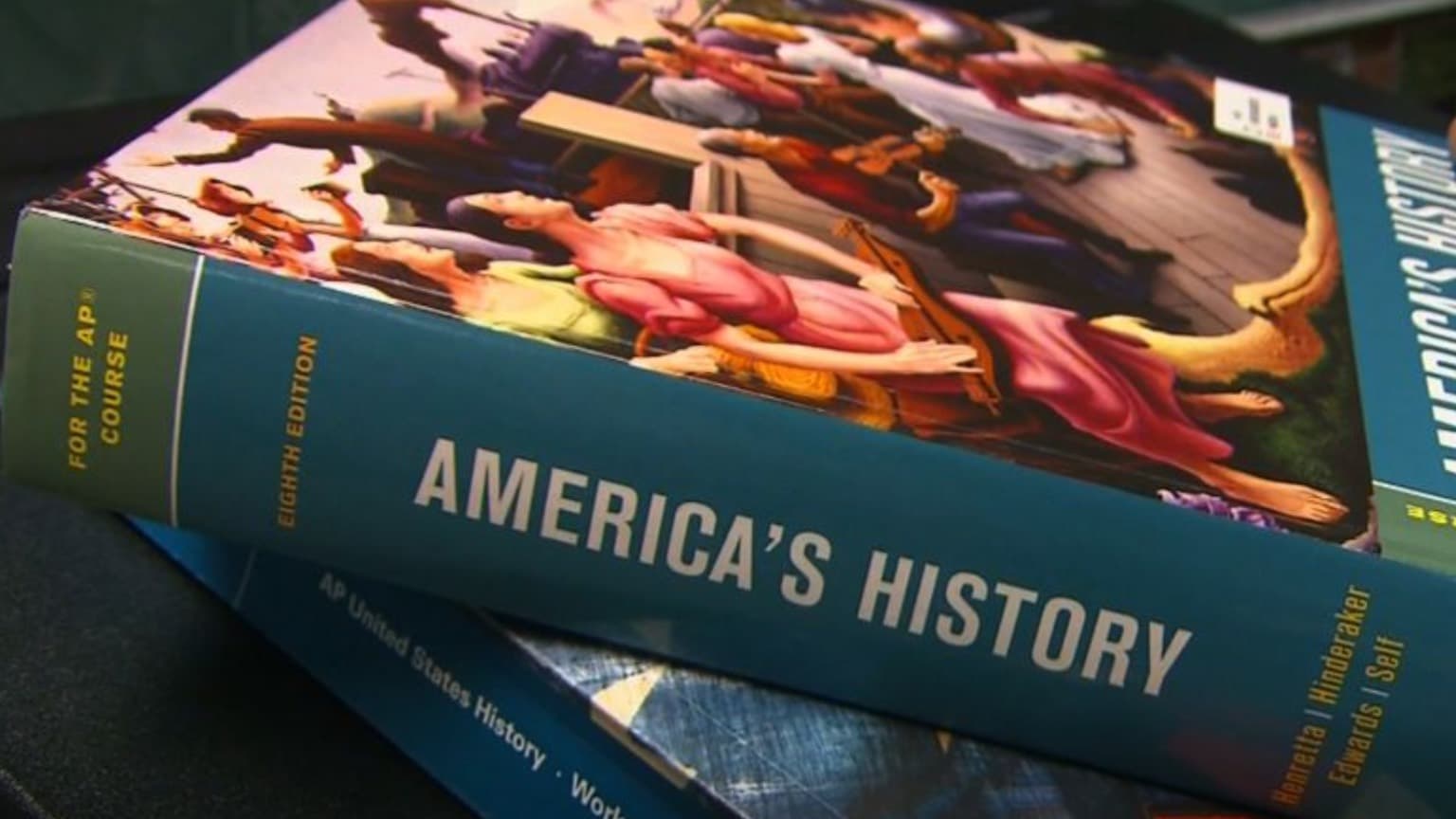 A thick book on its side, with "American's History" on the spine